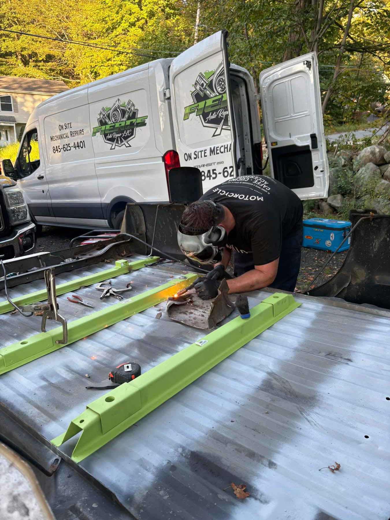 Fierce Auto Repair technician welding beside the mobile service van